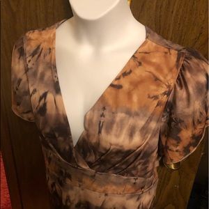 Short sleeve blouse with back open. Has a belt with it. Multi colors tiedye